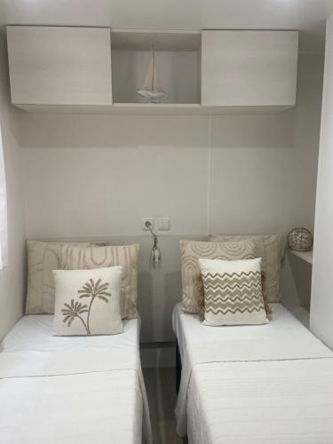 two beds in a room with white walls at Chiclavie in La Celle-sous-Gouzon