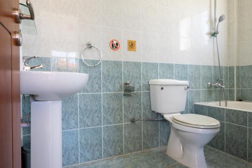 a bathroom with a toilet and a sink at Villa Aspasia in Peyia, Private Pool & 3 Ensuite Bedrooms in Paphos