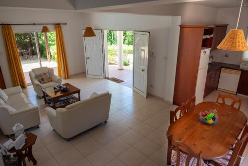 a living room with a table and a dining room at Villa Aspasia in Peyia, Private Pool & 3 Ensuite Bedrooms in Paphos