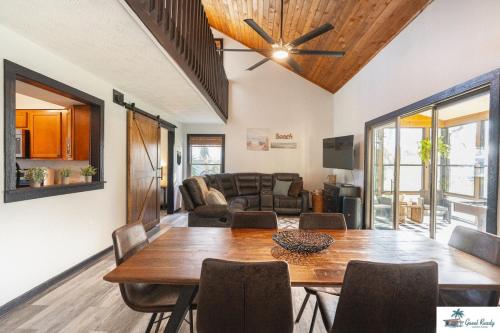 a living room with a table and a couch at Waterfront Zen-Dock, Paddleboards, Jacuzzi & Games in Saint Augustine