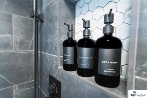three bottles of wine sitting on a shelf in a bathroom at Waterfront Zen-Dock, Paddleboards, Jacuzzi & Games in Saint Augustine