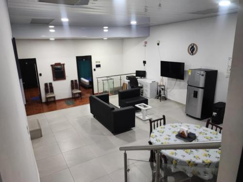a living room with couches and a table and chairs at Apartament in Santa Rosa de Cabal in Santa Rosa de Cabal
