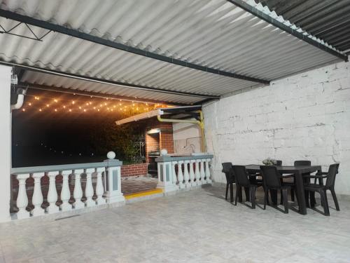 a patio with a table and chairs under awning at Apartament in Santa Rosa de Cabal in Santa Rosa de Cabal