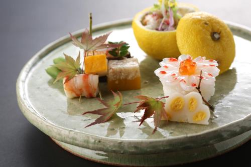 a plate with different types of food on it at Yamagamionsen Yunomotokan in Toki