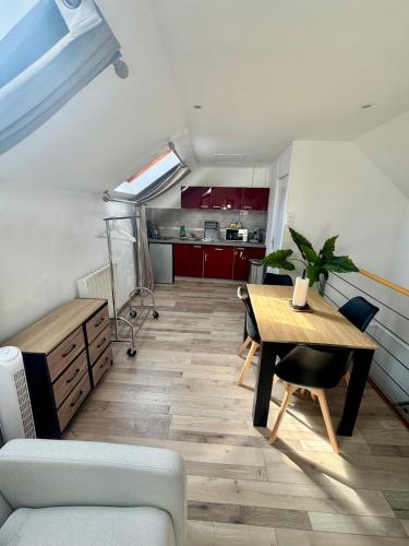 アミアンにあるLe Rooftop Amiénoisのテーブルとキッチンのあるリビングルーム