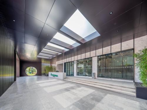 an empty lobby with a large skylight in a building at Holiday Inn Zhengzhou Zhongzhou by IHG in Zhengzhou