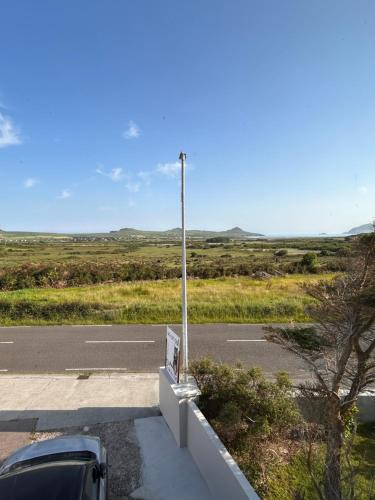 a car parked on the side of a road at An Cat Dubh - Luxury Apartment in Dingle