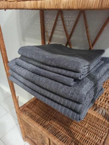 a stack of grey towels on a wicker rack at 2 patro v RD Vratimov in Vratimov