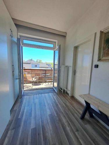 a room with a door open to a balcony with a bench at 2 patro v RD Vratimov in Vratimov