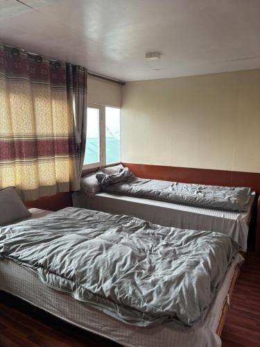 Postel nebo postele na pokoji v ubytování Hotel Sherpa Village