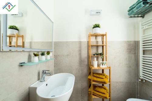 a bathroom with a sink and a towel rack at La Mansarda Chic by TuscanyWeGo in Prato
