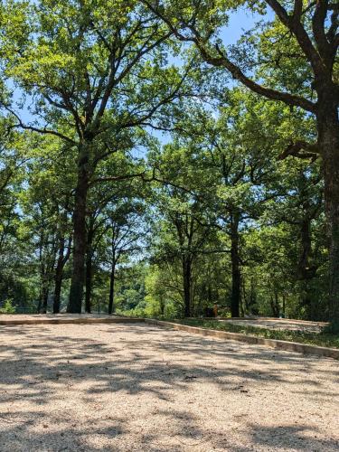 an empty parking lot with trees in the background at Hob La Truffière in Gignac
