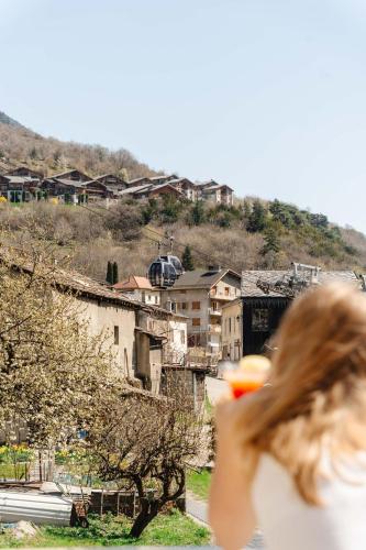 une femme tenant un frisbee devant une ville dans l'établissement Hob Orelle - Les 3 Vallées Val Thorens, à Orelle