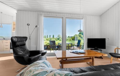 a living room with a couch and a table at Stunning Home In Haderslev With Sauna in Haderslev