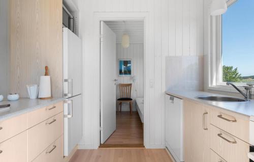 a kitchen with white cabinets and a sink and a window at Stunning Home In Haderslev With Sauna in Haderslev