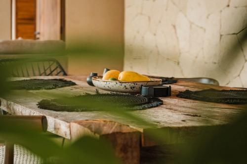 a table with a bowl of fruit on top of it at Ka'ana Condo in Tulum