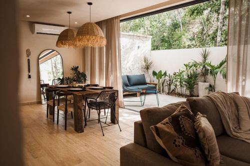 a living room with a couch and a table at Ka'ana Condo in Tulum