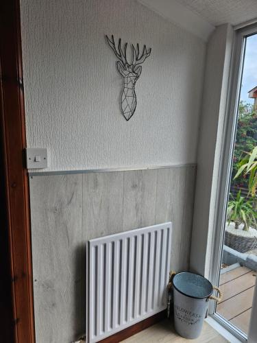a wall with a picture of a deer on the wall at Westview in Buckie