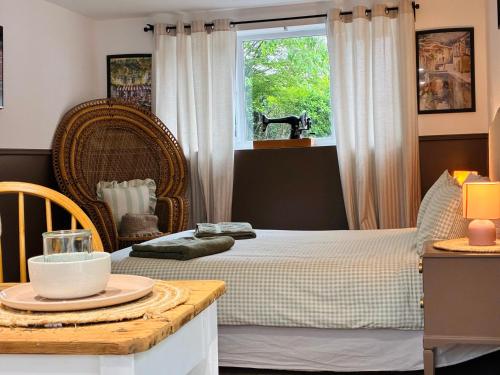a bedroom with a bed and a window at South Downs Haven nr Petersfield and Goodwood in Buriton