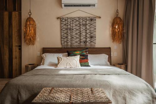 a bedroom with a large bed with a tray on it at Ka'ana Condo in Tulum