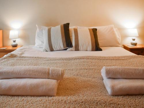a bedroom with a bed with towels on it at Uk46717 - The Orchard in Plumstead