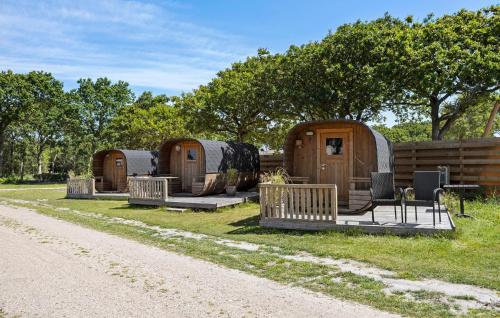 a group of three yurt homes sitting in the grass at Gorgeous Home In Tarm With Kitchen in Tarm