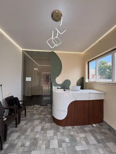 an office with a reception desk and a mirror at Rio Grande ApartHotel in Madurai