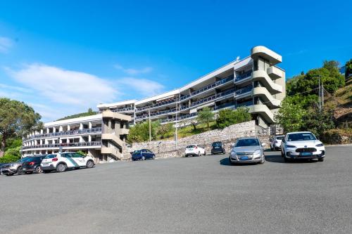 a parking lot with cars parked in front of a building at Approdo in Chiavari