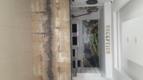 a hallway in a building with a painting on the wall at Altunakar 1 Hotel in Didim