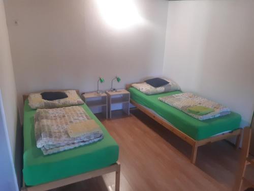 a room with two beds in a room at Apartmány Kroměřížsko in Hulín