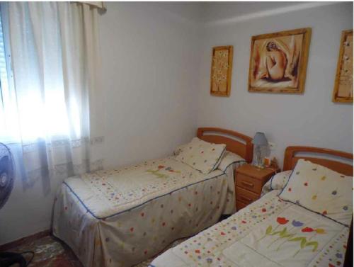 a bedroom with two beds and a window at Torrox costa apartamento in Torrox Costa