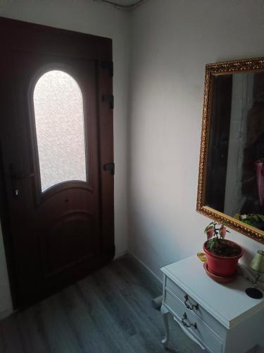 a room with a door and a mirror and a table at Casa de pueblo in Gea de Albarracín