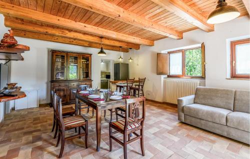 a dining room with a table and chairs and a couch at Gorgeous Home In Loc Avenale, Cingoli in Avenale
