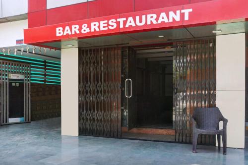 a chair in front of a building with a restaurant at FabHotel Ajinkya Executive in Pune