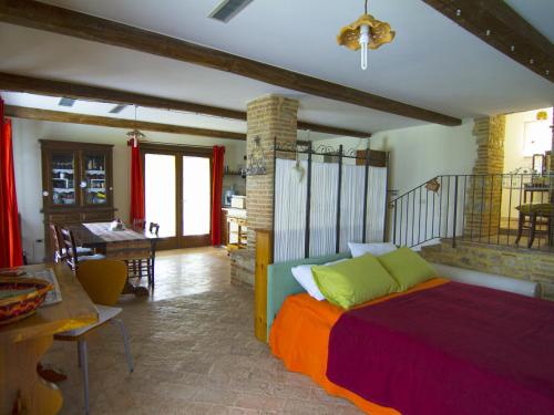 a bedroom with a bed and a dining room at Il giardino segreto in Contigliano