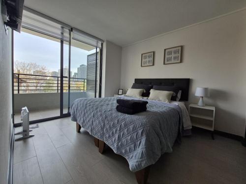 Ένα ή περισσότερα κρεβάτια σε δωμάτιο στο Acogedor departamento en Ñuñoa