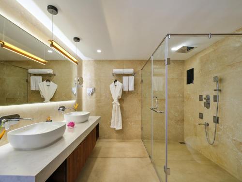 a bathroom with two sinks and a shower at Sterling Lake Palace Alleppey in Alleppey