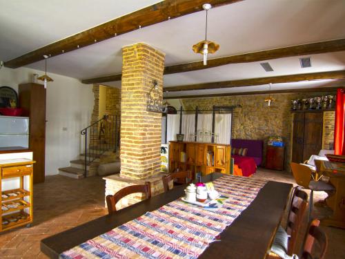 a dining room with a table and a brick pillar at Il giardino segreto in Contigliano