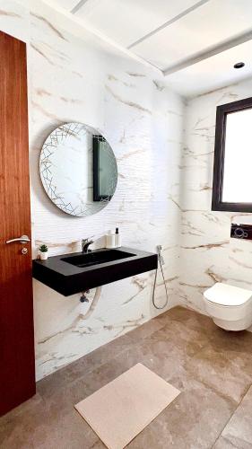 a bathroom with a sink and a mirror at Luxury apartment near golf beach in Cabo Negro