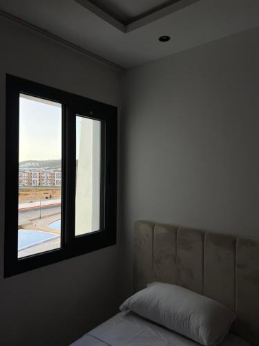 a bedroom with a couch and a window at Luxury apartment near golf beach in Cabo Negro