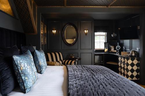 a bedroom with a bed and a living room at Talland Bay Hotel, Looe in Talland