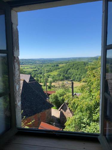 an open window looking out at the countryside at Le Malaval in Saint-Solve