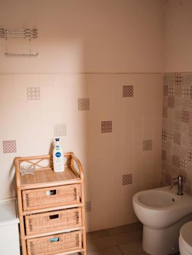 a bathroom with a sink and a toilet and a tub at La stamberga nel bosco in Asciano Pisano