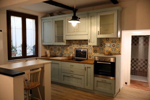 a kitchen with white cabinets and a counter top at La casa di Giacomo in Portovenere