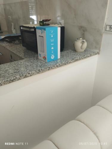 a microwave oven sitting on a counter next to a stove at kelibia ezzahra plage a pied in Kelibia