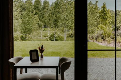 a table and chairs in front of a window at Hangar C gastensuites in Heers