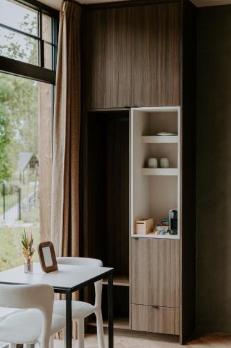a dining room with a table and a book shelf at Hangar C gastensuites in Heers