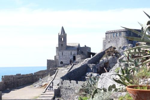 a building on a cliff next to the ocean at La casa di Giacomo in Portovenere