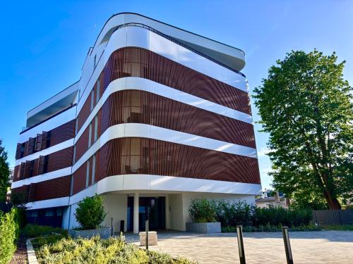 a building with red and white at Baltic Waves Resort & SPA Międzyzdroje 3 in Międzyzdroje