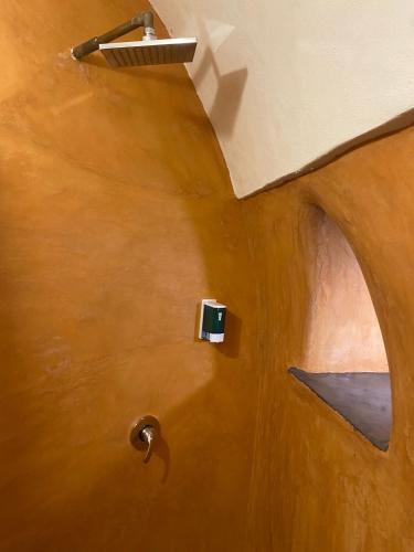 a bathroom with a wooden floor and a door at Horizon Pantelleria in Pantelleria